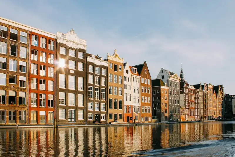 Assorted-color buildings beside body of water