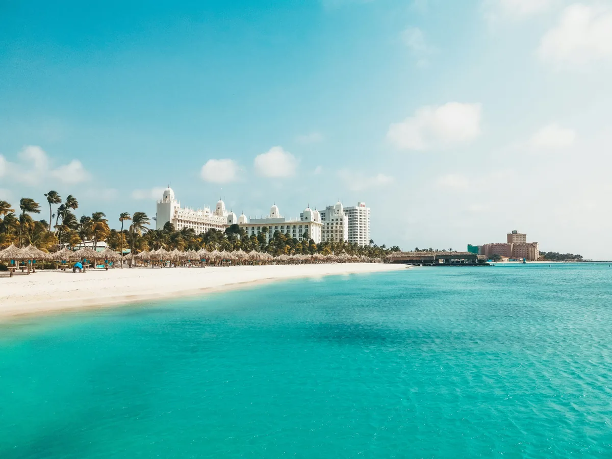 A view of a beach with a hotel in the background