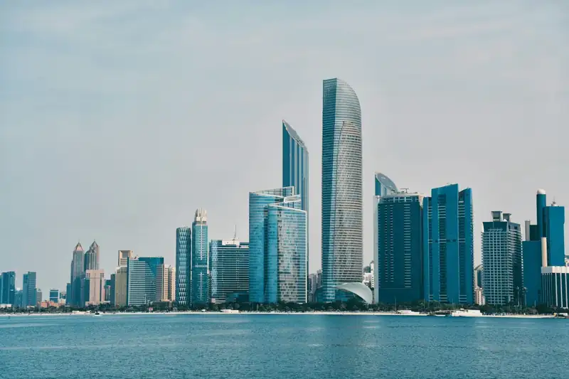 A city skyline with a body of water in the foreground