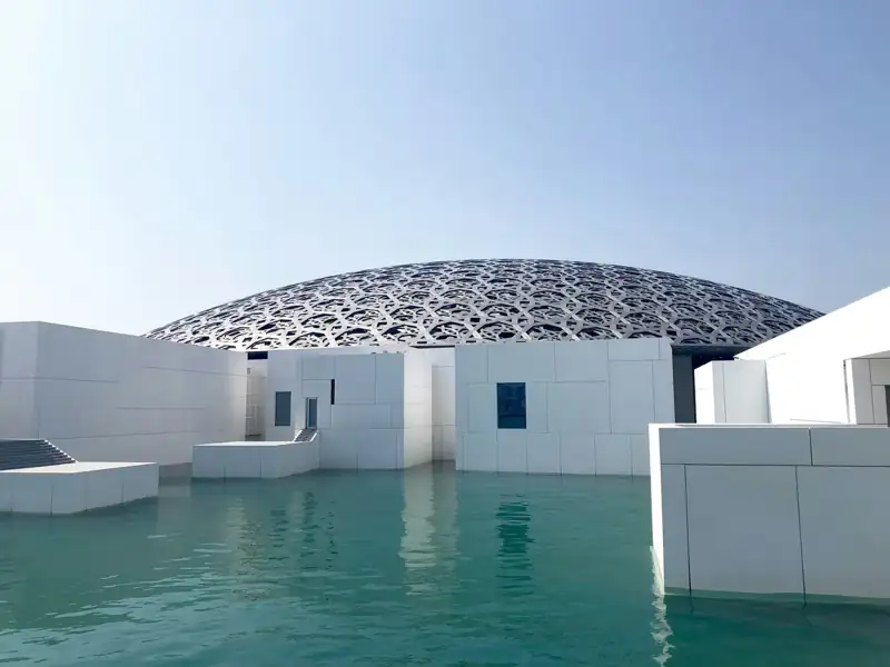 White concrete building near body of water during daytime