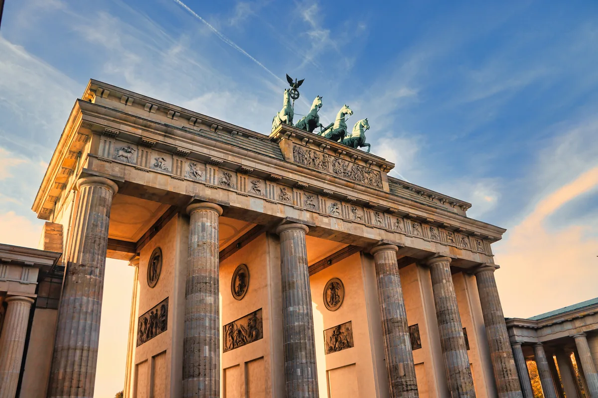 A very tall building with some statues on top of it