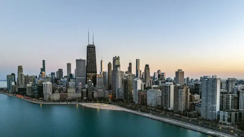 An aerial view of a large city next to a body of water