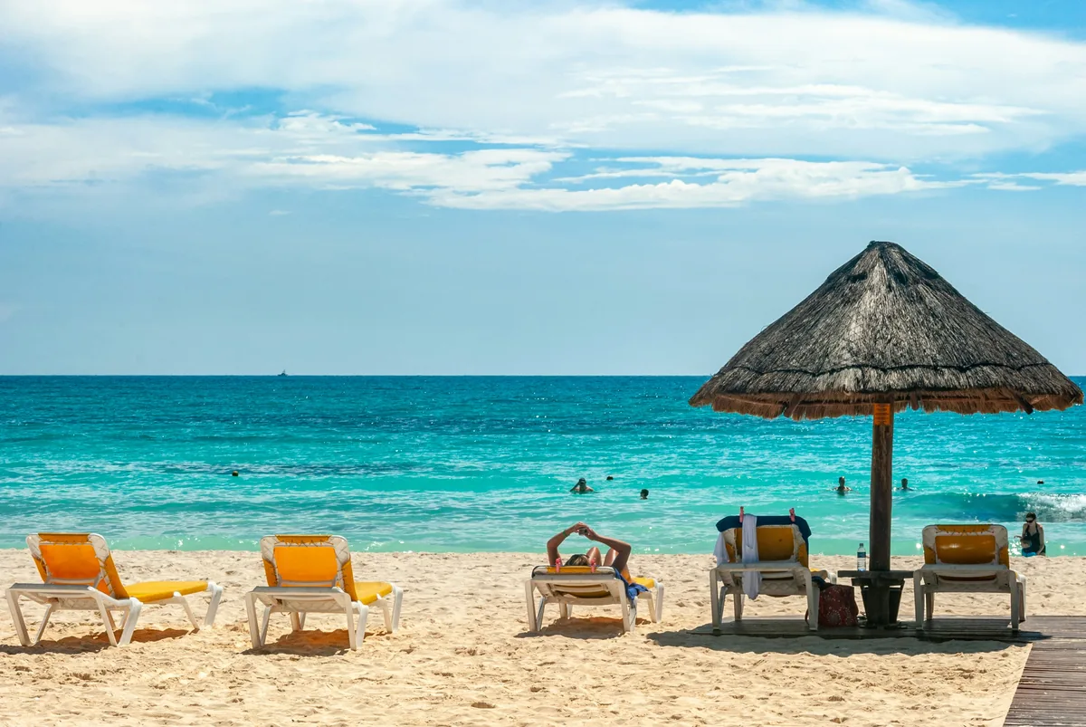 Brown beach umbrellas on beach during daytime