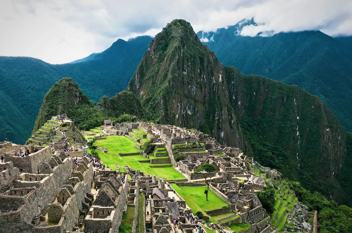 The ancient stone ruins of Machu Picchu nestled among lush green mountains in Peru