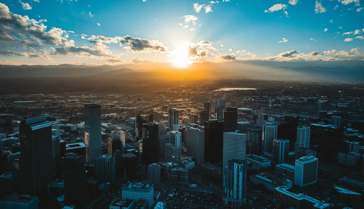 The sun is setting over a large city