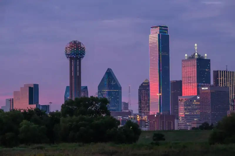 A view of a city skyline with a water tower in the foreground