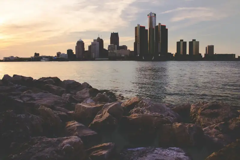 Skyline photography of city buildings under blue and white cloudy skies at daytime