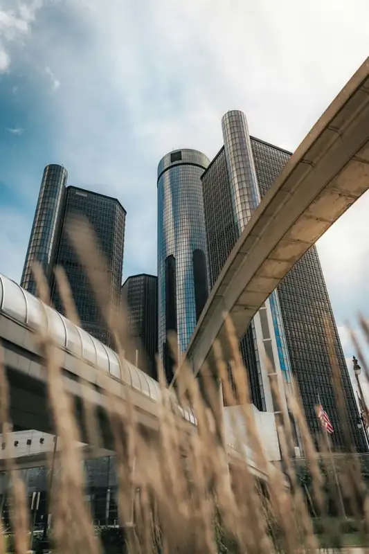 Modern skyscrapers with elevated train track and dry grass