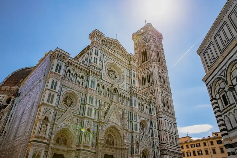 A tall cathedral with a clock on the front of it