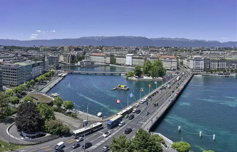 Aerial view of city buildings near body of water during daytime