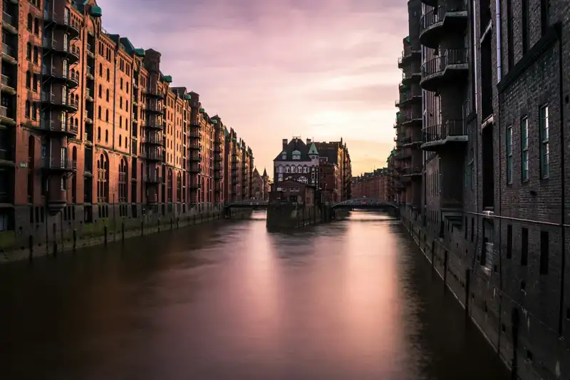 Lake view surrounded by concrete building during daytime