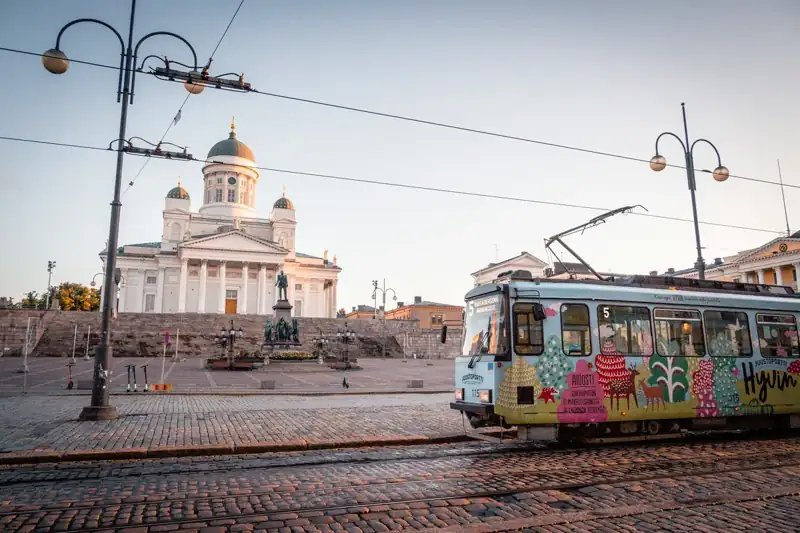 White and yellow tram on road near white concrete building during daytime