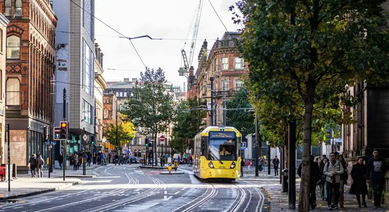 Yellow and black tram on road during daytime