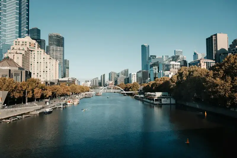 City skyline with river and trees on a clear day