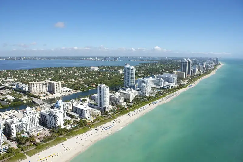 An aerial view of the coastline and high-rise buildings in Miami Beach, Florida