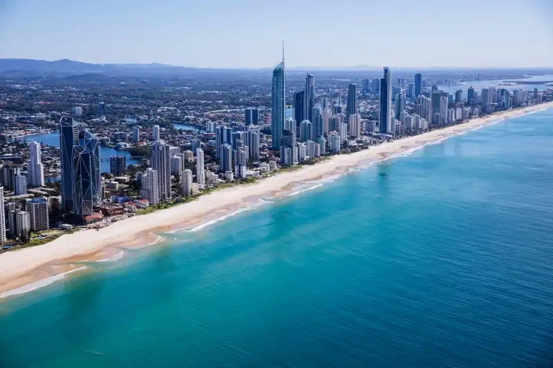 Aerial view of city buildings near sea during daytime