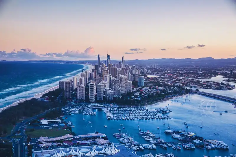 Aerial view of city buildings near body of water during daytime