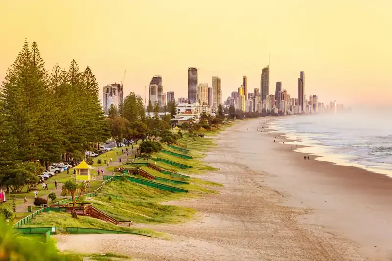 People on beach near high rise buildings during daytime