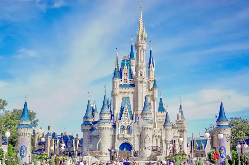 A large castle with a lot of people around it