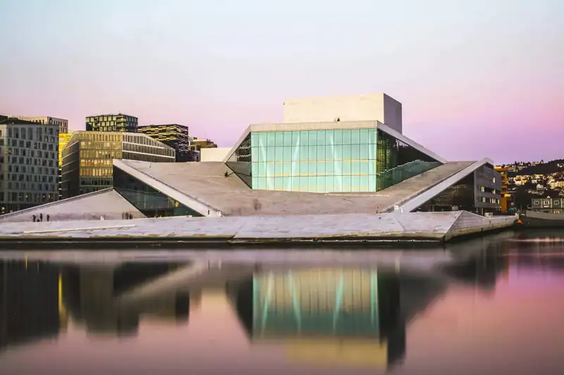 Brown and white concrete building near body of water during daytime
