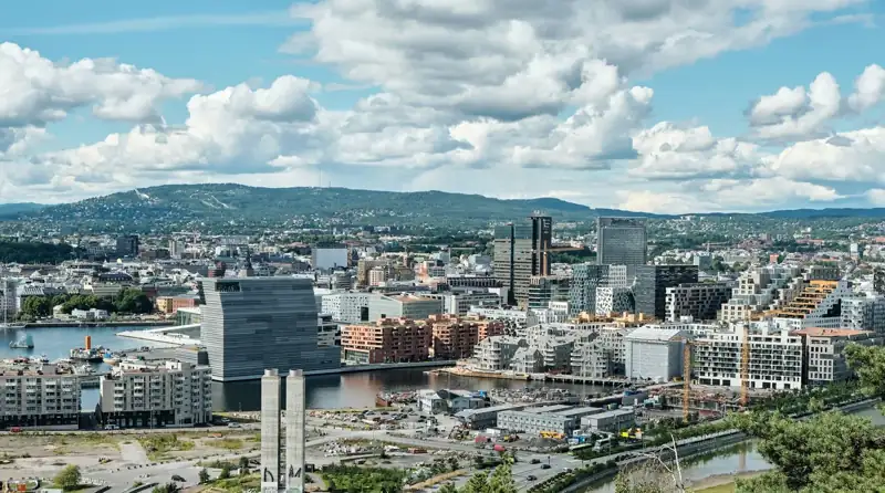 City buildings under white clouds and blue sky during daytime