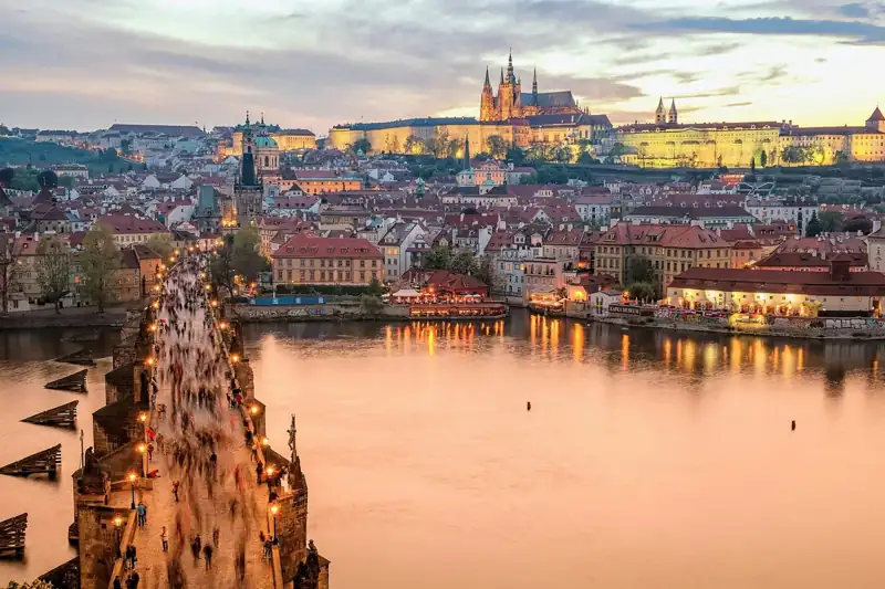 Charles Bridge and Prague Castle illuminated during the golden hour in Prague, Czechia
