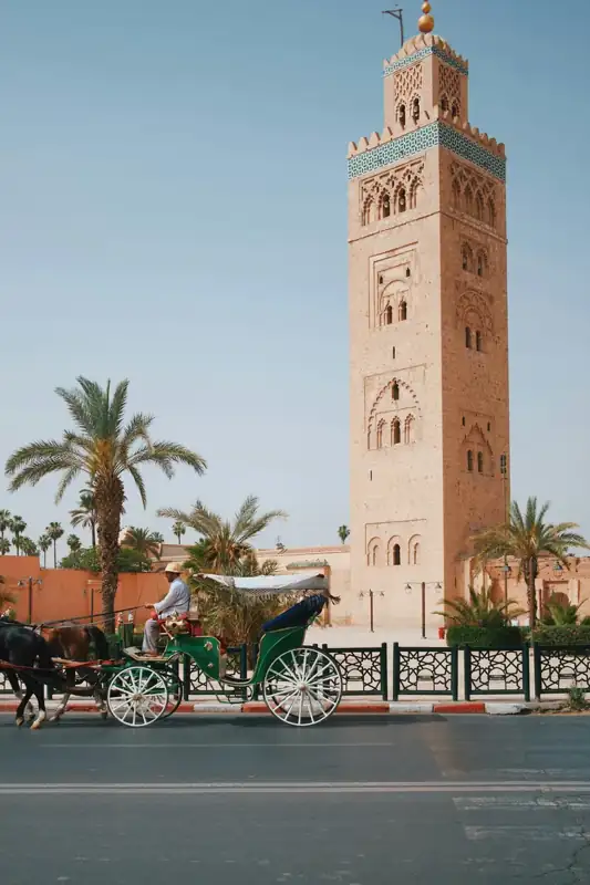 A horse-drawn carriage passing the Koutoubia Mosque in Marrakech, Morocco