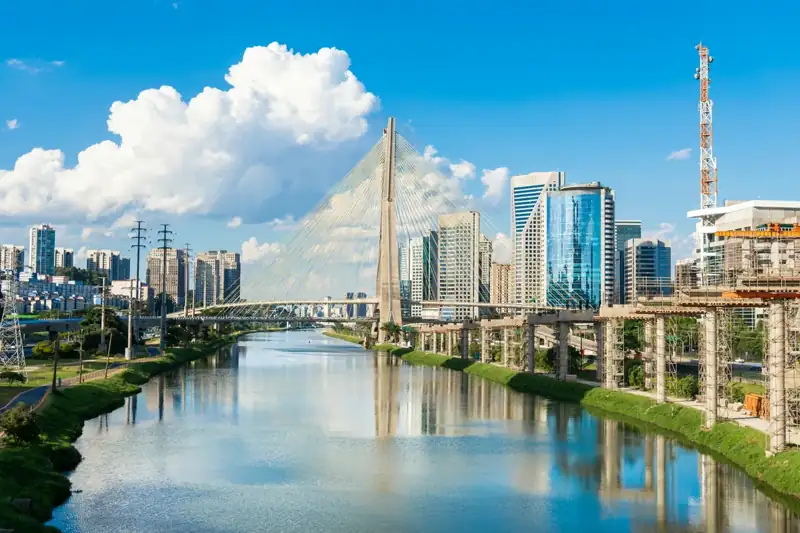 A river running through a city next to tall buildings