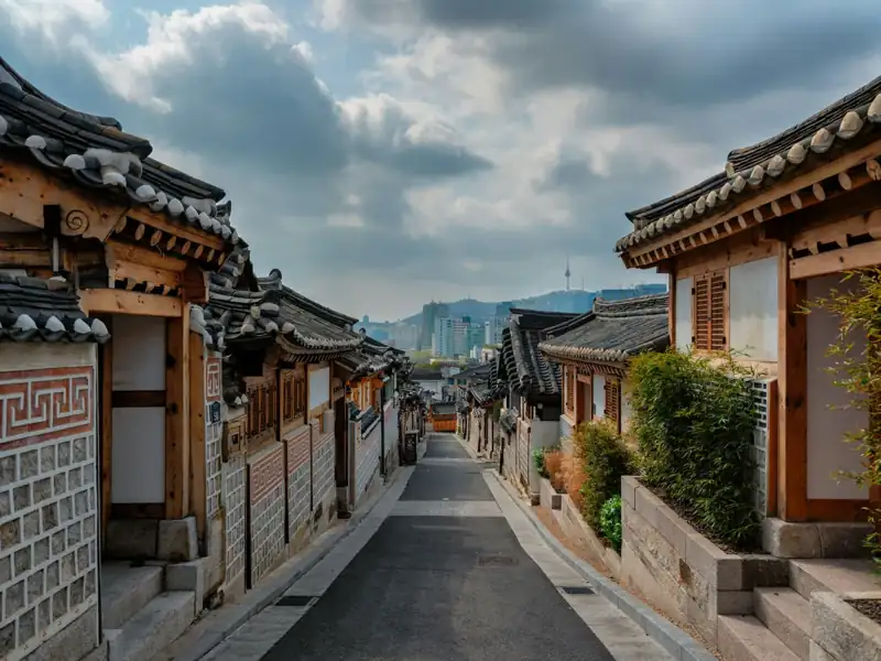 A street lined with wooden buildings under a cloudy sky