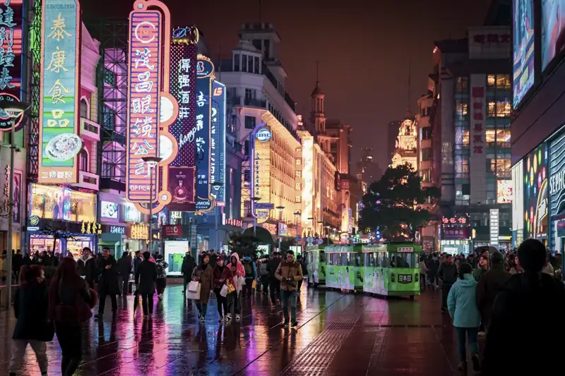 People walking and standing at the streets of the city during night