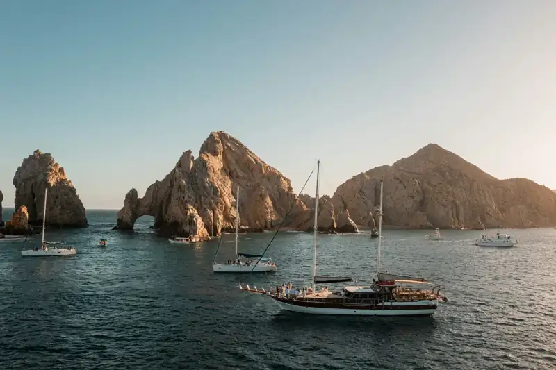 A group of boats floating on top of a body of water