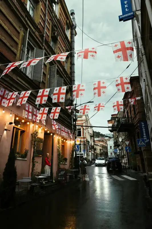 Georgian flags strung across a narrow city street