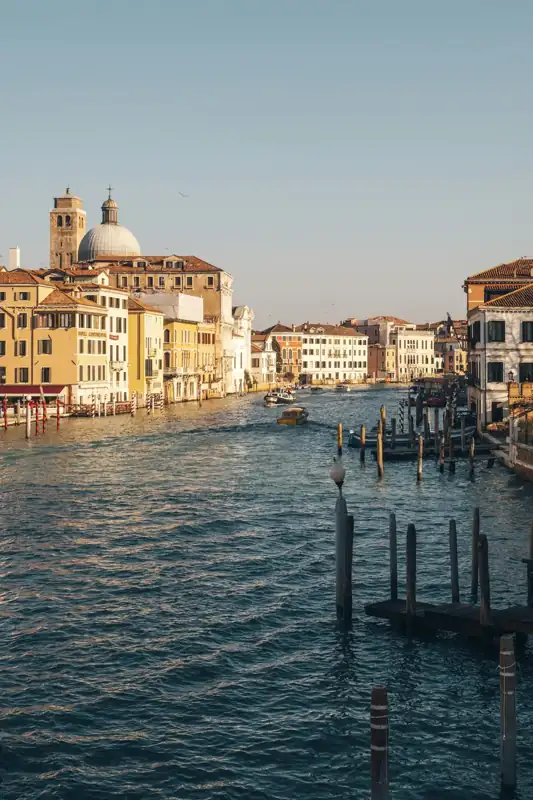 Boats on a canal lined with historic buildings in venice